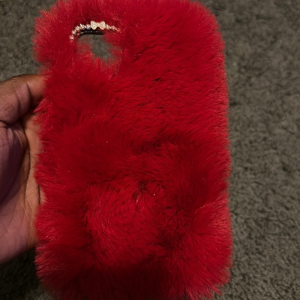 This is a fuzzy red case for a iPhone 11 pro max. There is a few little scratch. - Picture 1 of 4